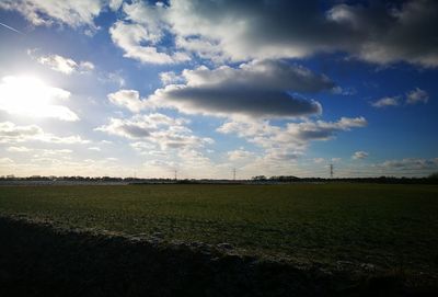 Scenic view of field against sky at sunset