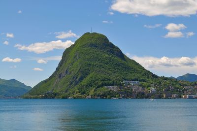 Lanscape view of the beautiful monte san salvatore and the lake lugano on a sunny day