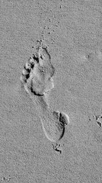 High angle view of footprints on sand at beach