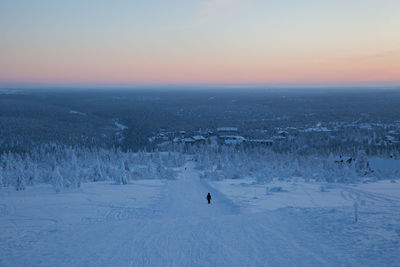 Snow covered ground against sky