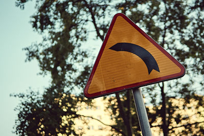 Low angle view of road sign against sky