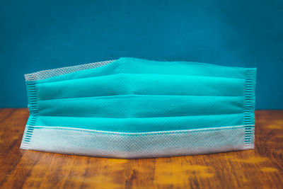 Close-up of blue stack on table against white background