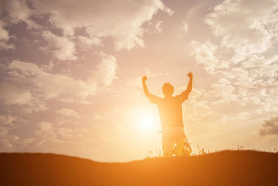 Silhouette man standing against sky during sunset