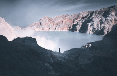 Person standing on rocky mountain