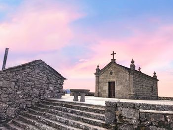 Old building against sky during sunset