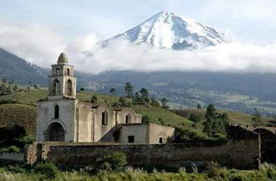 View of church and mountains against sky