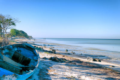 Scenic view of beach against clear blue sky