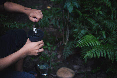 Midsection of man holding drink