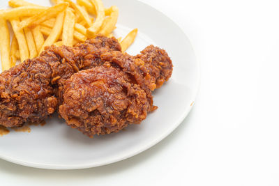 Close-up of food in plate on white background