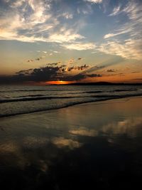 Scenic view of beach against sky during sunset