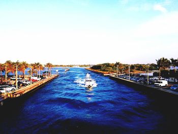 Boats in river with buildings in background