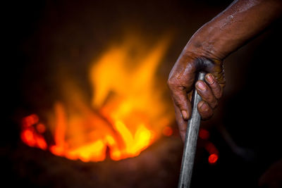 Close-up of man working on fire