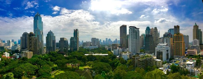 View of cityscape against cloudy sky