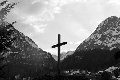 Panoramic view of cross on mountain against sky