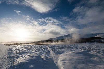 Scenic view of frozen lake against sky