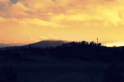 Scenic view of landscape against sky at sunset