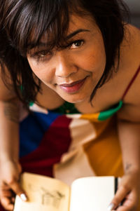 Portrait of smiling woman holding book