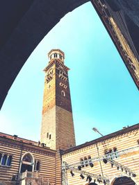 Low angle view of clock tower against blue sky