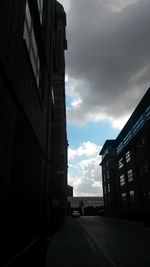 Buildings in city against cloudy sky