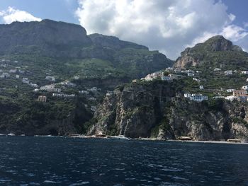 Scenic view of sea and mountains against sky