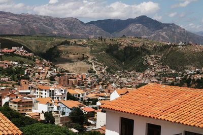 High angle view of townscape and mountains against sky