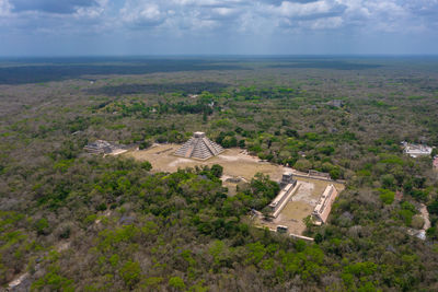 Aerial view of the beautiful chicen itza and mayan pyramid in mexico surrounded with jungle 