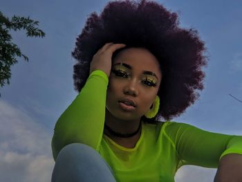 Portrait of beautiful young woman against sky