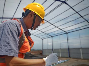 Side view of man working at construction site