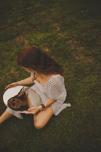 High angle view of woman holding umbrella on field