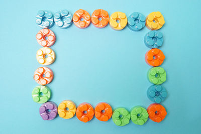 Directly above shot of multi colored candies against blue background