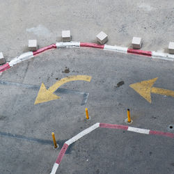 High angle view of arrow sign on road