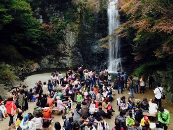 High angle view of people by waterfall in forest