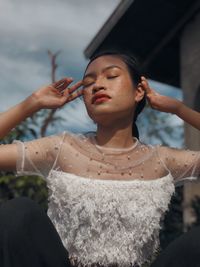 Portrait of young woman smoking cigarette