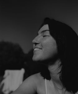 Portrait of woman looking away against sky