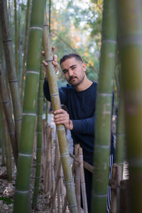 Moroccan man holding a bamboo stem in a public park