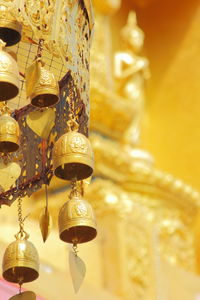 Low angle view of illuminated lanterns hanging on ceiling of building