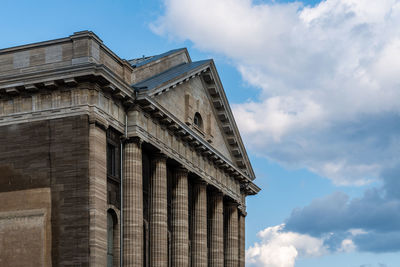 Low angle view of building against cloudy sky