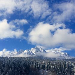 Low angle view of snowcapped mountains against sky