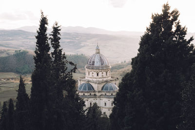 Castle by trees against sky