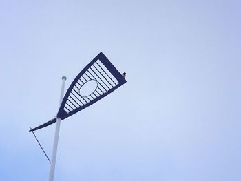 Low angle view of windmill against clear blue sky