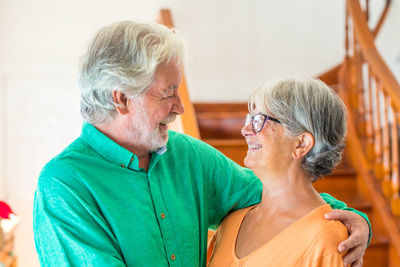 Happy couple kissing against blurred background