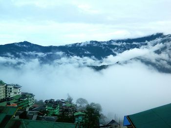 Scenic view of mountains against cloudy sky