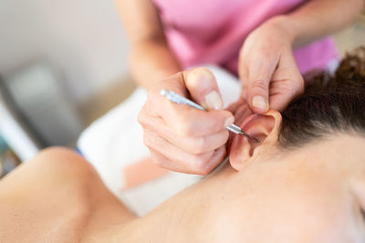 Midsection of doctor examining patient