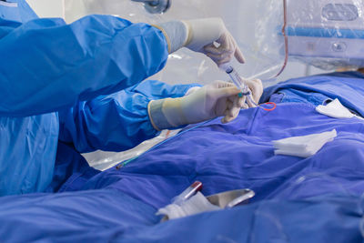 Midsection of doctor examining patient in hospital