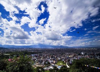 High angle view of city against cloudy sky