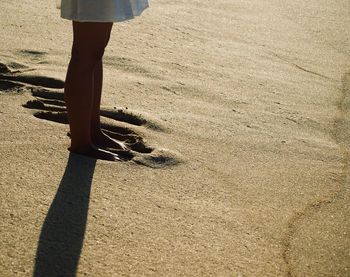 Low section of woman standing on beach