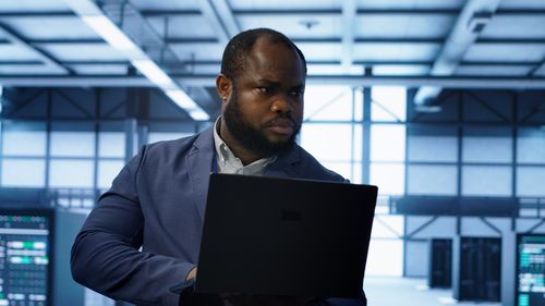 Man using laptop at airport