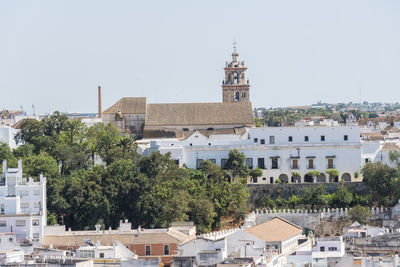 Buildings in city against clear sky