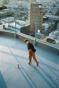 High angle view of woman with dog on city