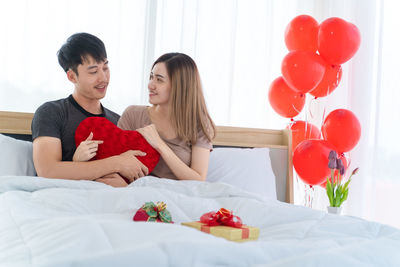 Couple kissing on a balloons